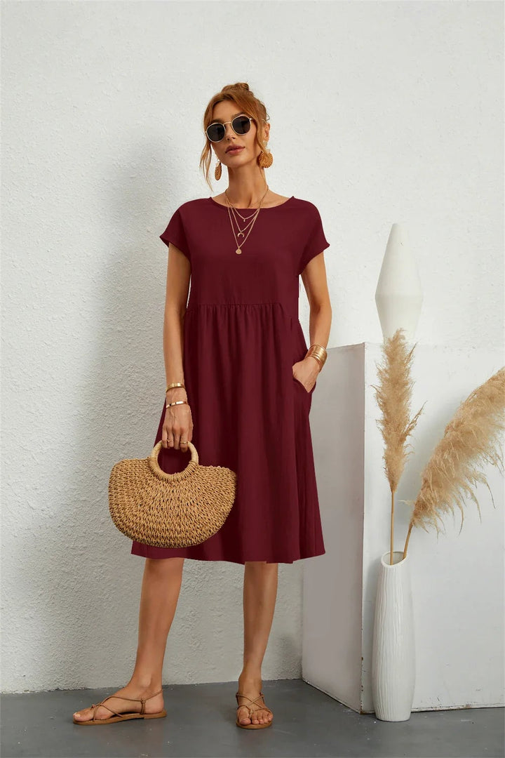 Casual pocket dress in white colorway, shown styled with minimal accessories for a clean fresh look