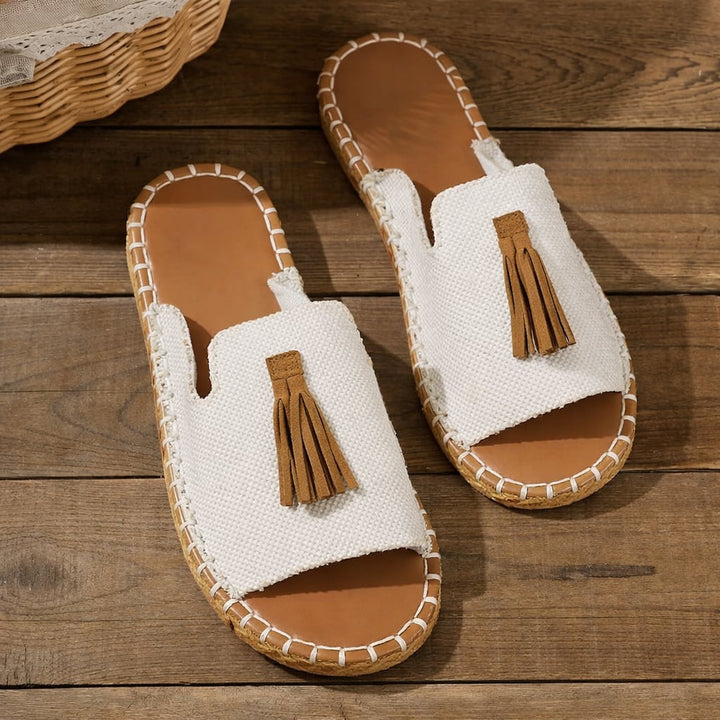 Woman wearing Robin flat sandals while walking outdoors on a sunny day