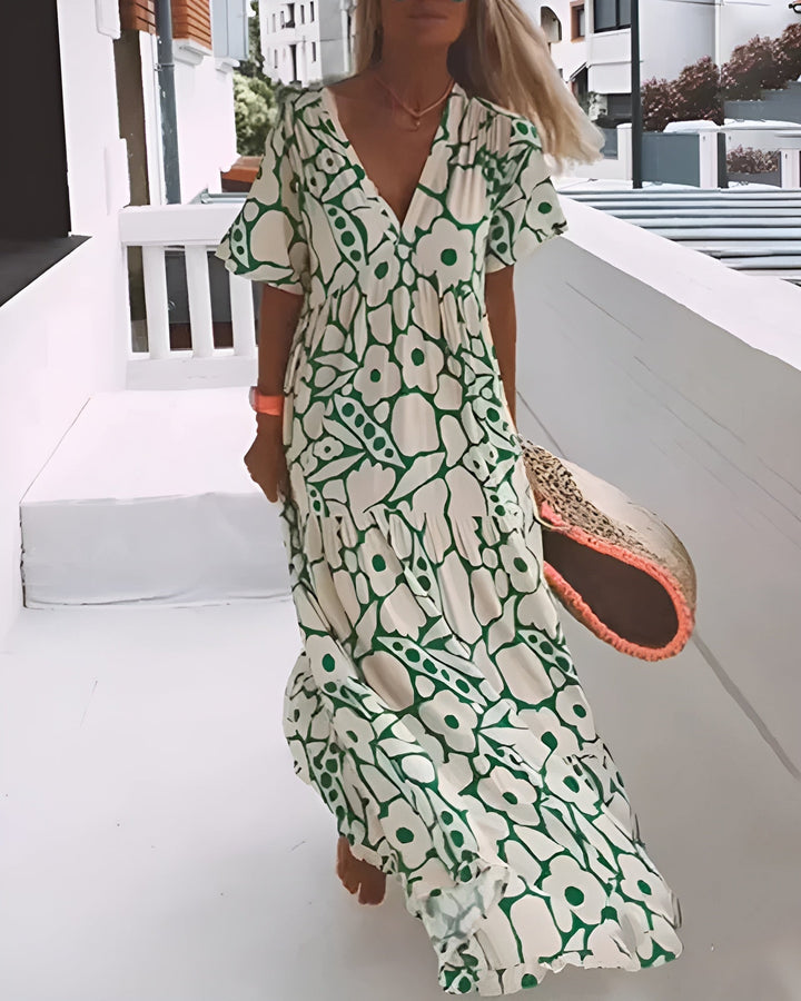 Woman wearing a flowy green A-line summer dress with a soft V-neckline, shown from the front