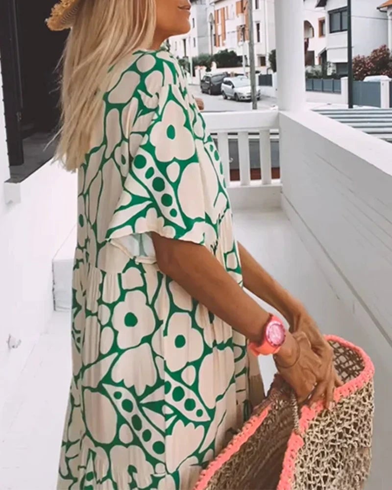 Full-length shot of the Robyn summer dress in green, highlighting the flowing A-line skirt