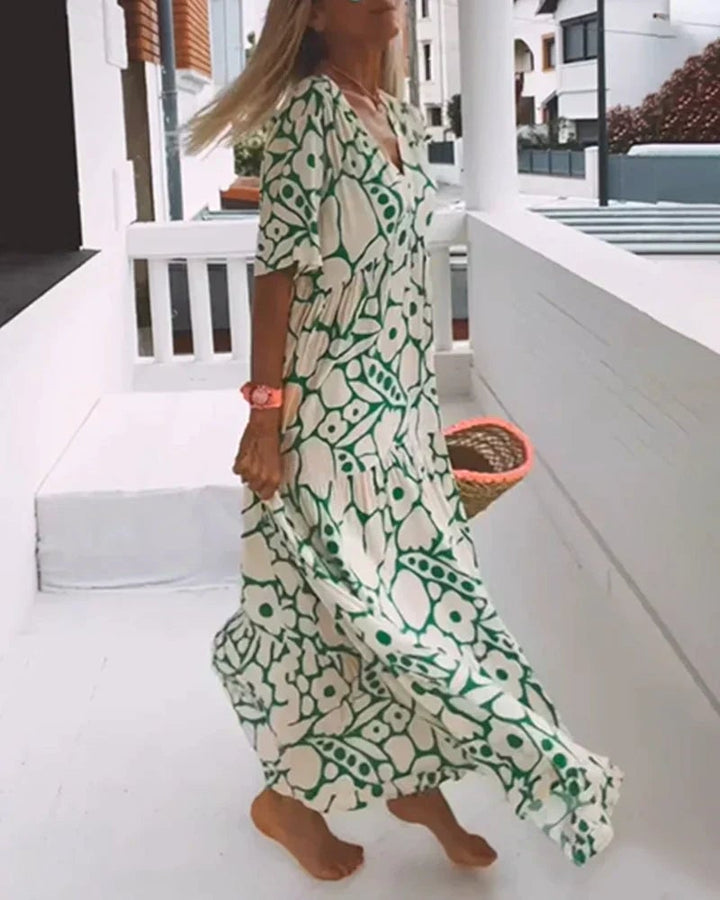 Woman in a yellow flowy summer dress styled with sandals for a casual vacation look