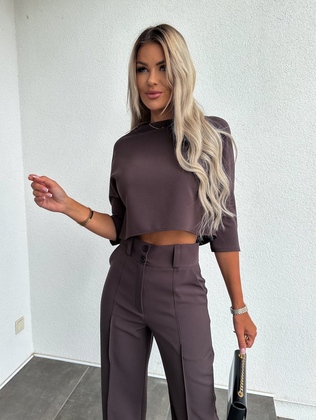 Overhead flat lay of the two-piece lounge set in black showing the top and pants together