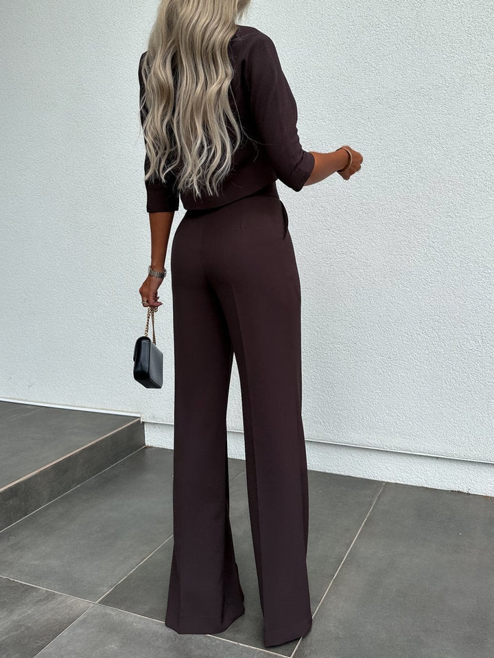 Model wearing the white two-piece lounge set in a relaxed seated pose