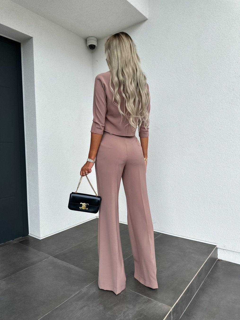 Side view of the white high-waisted lounge pants highlighting the sculpted fit