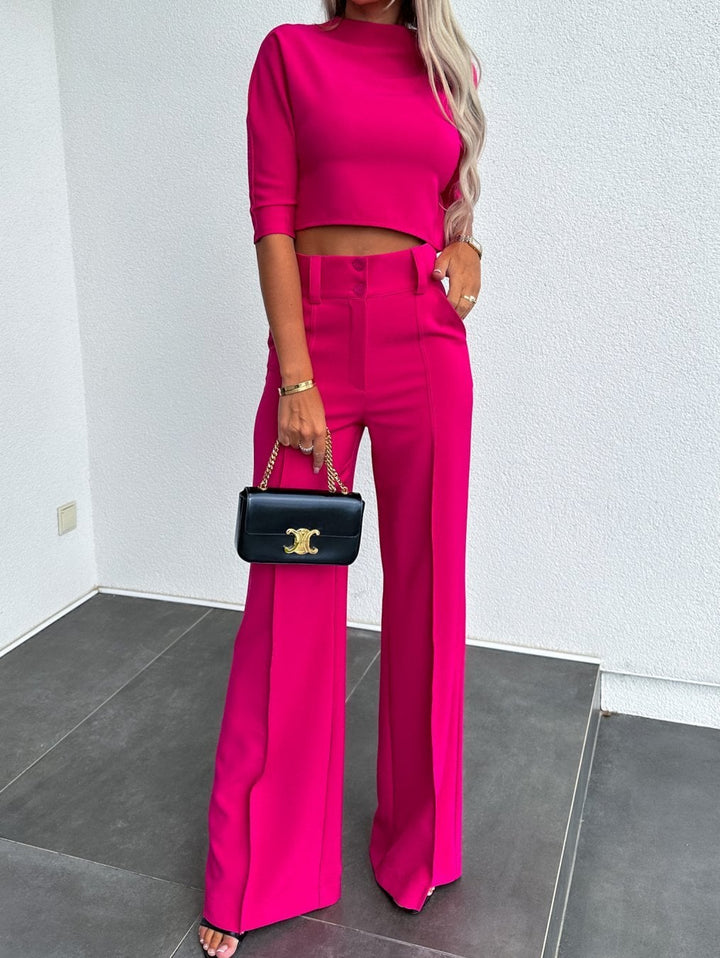 Two-piece lounge set in white styled with simple gold jewelry accessories