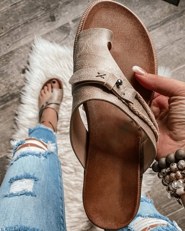 Close-up of Roma sandal toe ring loop and metal stud accents on wide crossover strap