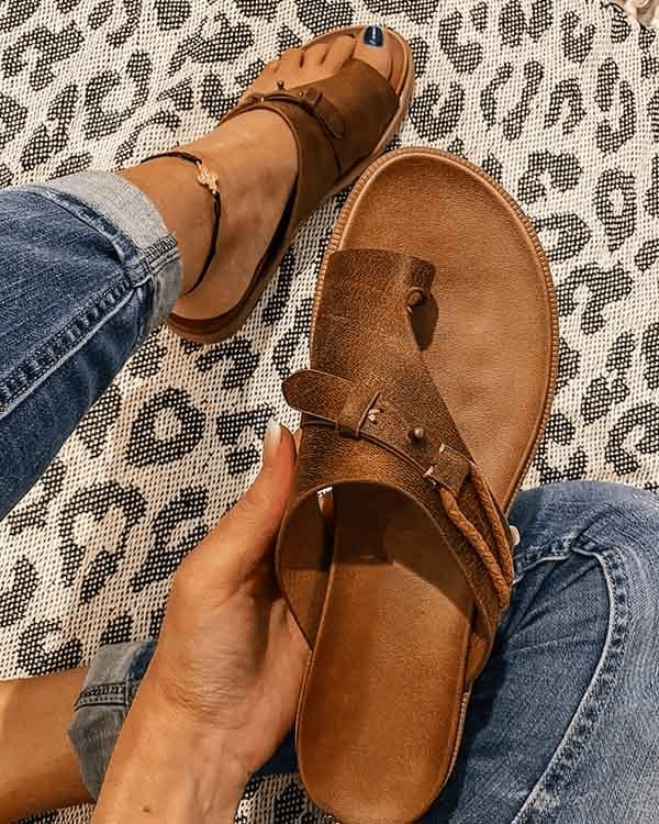 Roma flat slide sandals in brown with contoured cushioned footbed, side view