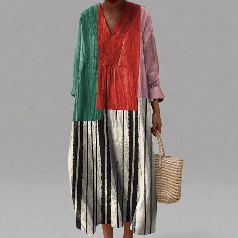 Woman wearing an elegant geometric-print maxi dress with a flowing silhouette in bold dream-inspired patterns