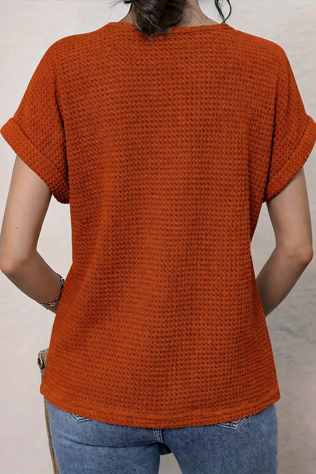 Red round neck lace trim top worn by a model at a garden-inspired setting