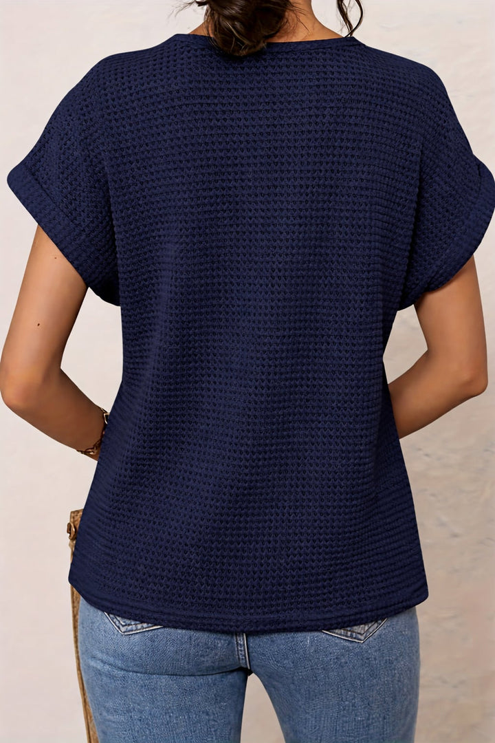 White lace trim top on a model, highlighting the delicate neckline detail and relaxed cut