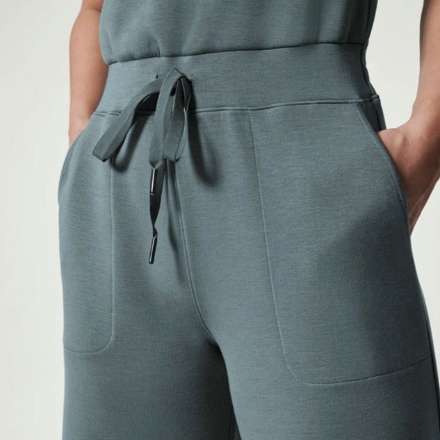 Flat lay of the Rosalie jumpsuit in black showing the sleeveless cut and clean minimalist design