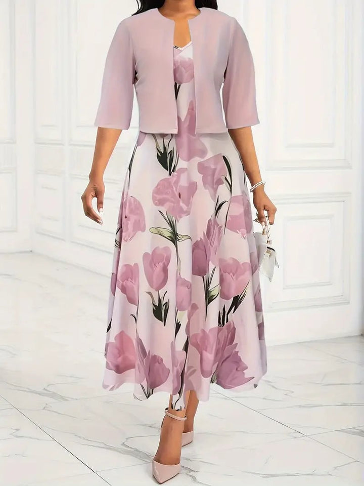 Woman wearing a pink floral maxi dress set with a 3/4 sleeve coordinating jacket, full front view