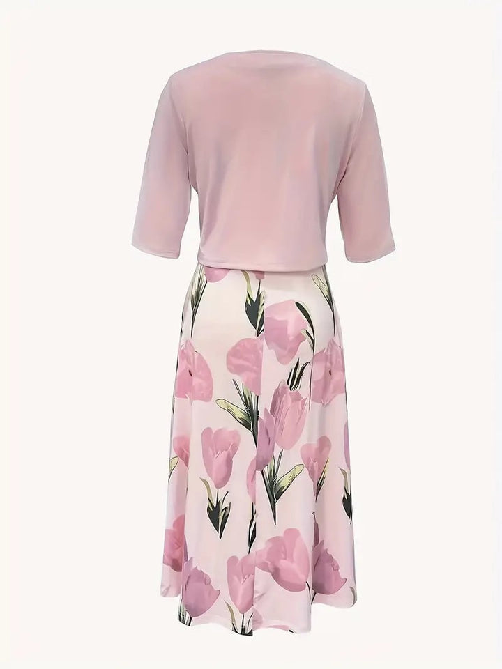 Side view of woman in pink floral maxi dress set with jacket, showing floor-length flowing silhouette