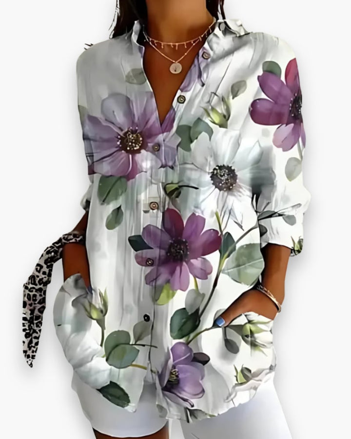 Rosalie floral blouse in lilac print, showing relaxed straight cut and white button detail