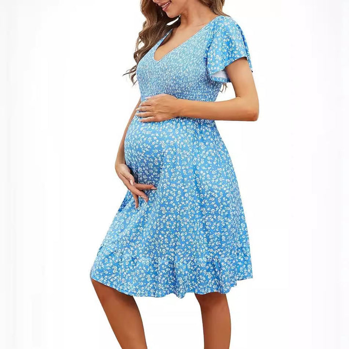 Side profile of the Rosalind maternity dress in sky blue, highlighting the empire waist and flowing silhouette