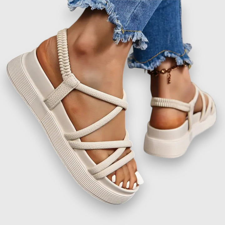 Side profile of the Rosalind beige sandal showing cushioned footbed and slim strap