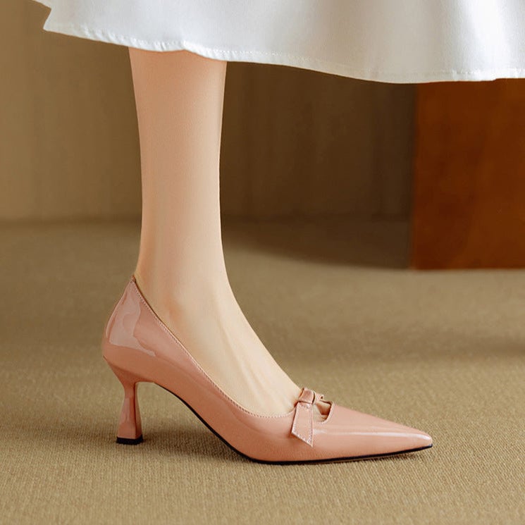 Rosalind blush pink pumps showing flared kitten heel and pointed toe from rear angle