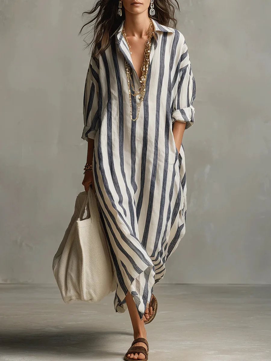 Woman wearing a striped long sleeve maxi shirt dress with a V-neckline in a flowing ankle-length silhouette