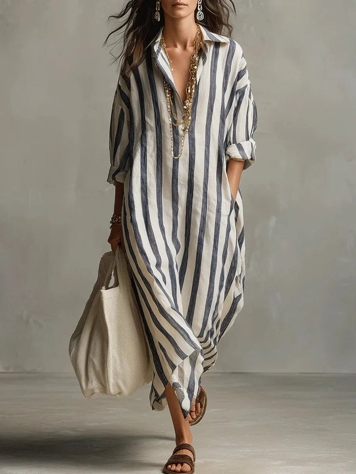 Woman wearing a striped long sleeve maxi shirt dress with a V-neckline in a flowing ankle-length silhouette
