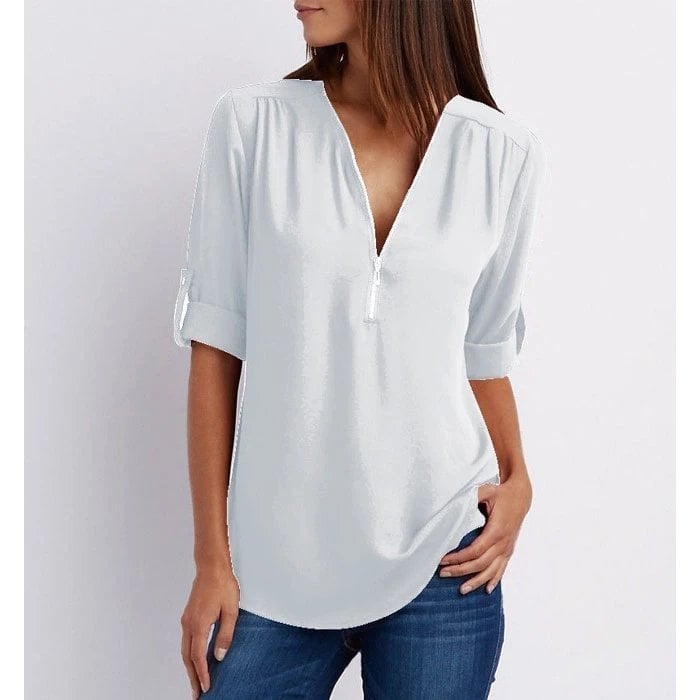 Side view of the Rosé casual blouse in pink showing the relaxed fit and curved hem