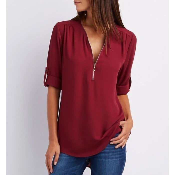 Close-up of the silver zip V-neckline and cuffed roll-tab sleeve detail on the Rosé blouse