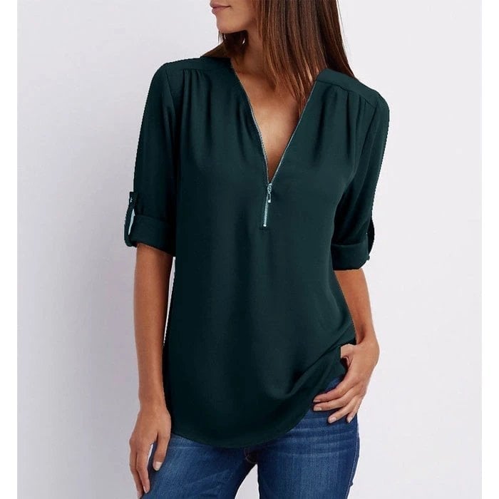 Flat lay of the Rosé zip-up V-neck blouse in dark green highlighting the overall silhouette and sleeve detail