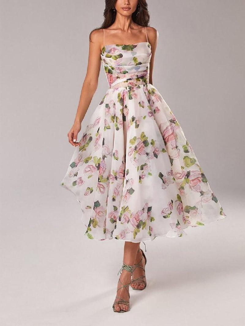 Woman wearing the Rosie pink watercolor floral spaghetti strap A-line midi dress with a draped cowl neckline, front view