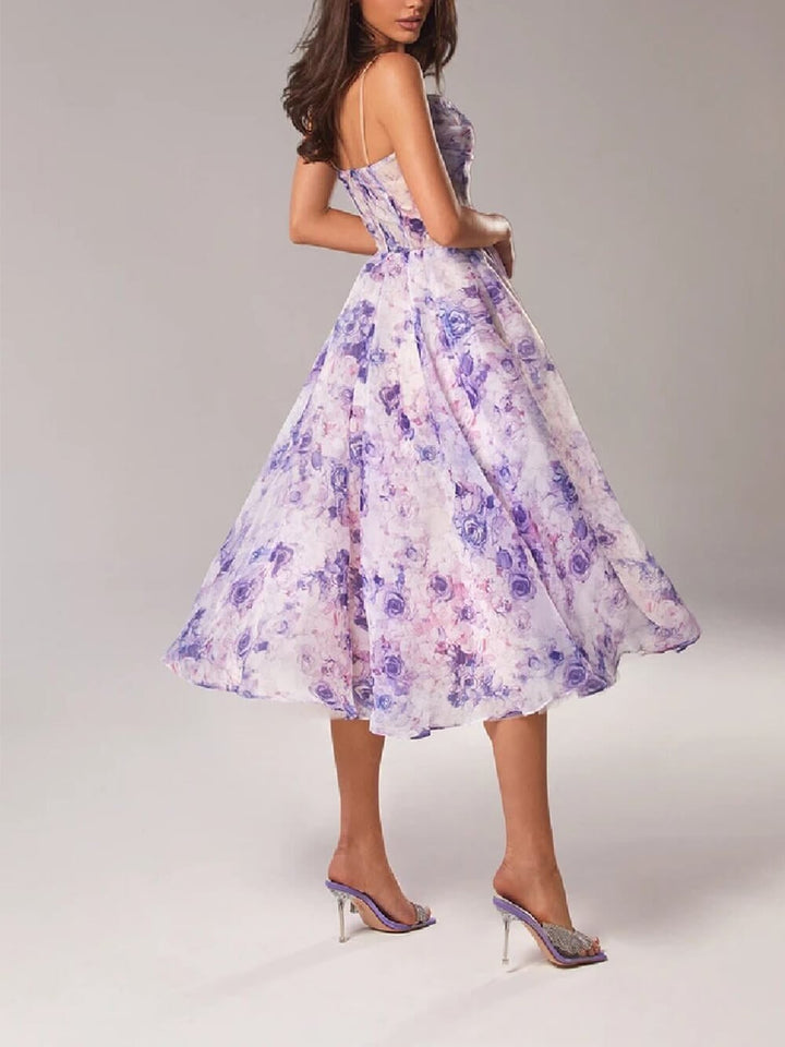 Woman wearing the Rosie floral midi dress in purple colorway, full-length A-line skirt with flowing movement