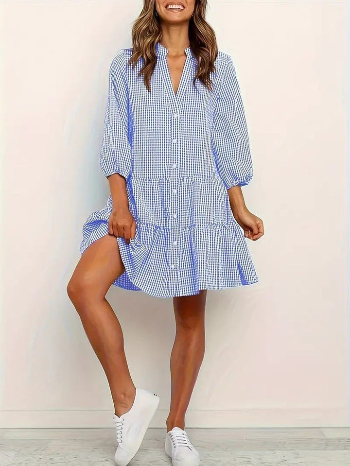 Side view of the Rosie gingham mini dress showing the tiered skirt and button-down placket in pink