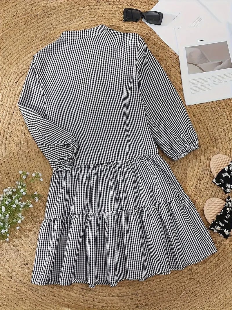 Lifestyle shot of model wearing the Rosie gingham mini dress styled with neutral sandals