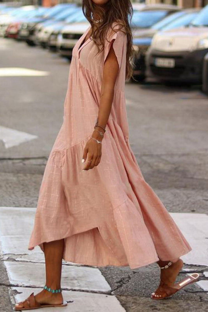 Flat lay of the Rosie tiered midi dress showing the tiered skirt and overall construction