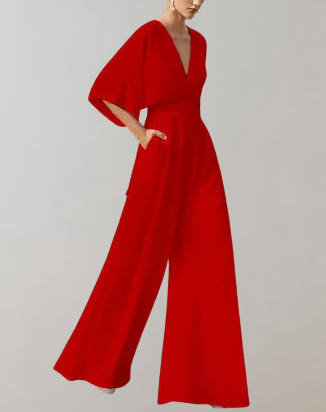 Back view of women's wide-leg V-neck jumpsuit in blush pink with draped batwing sleeves