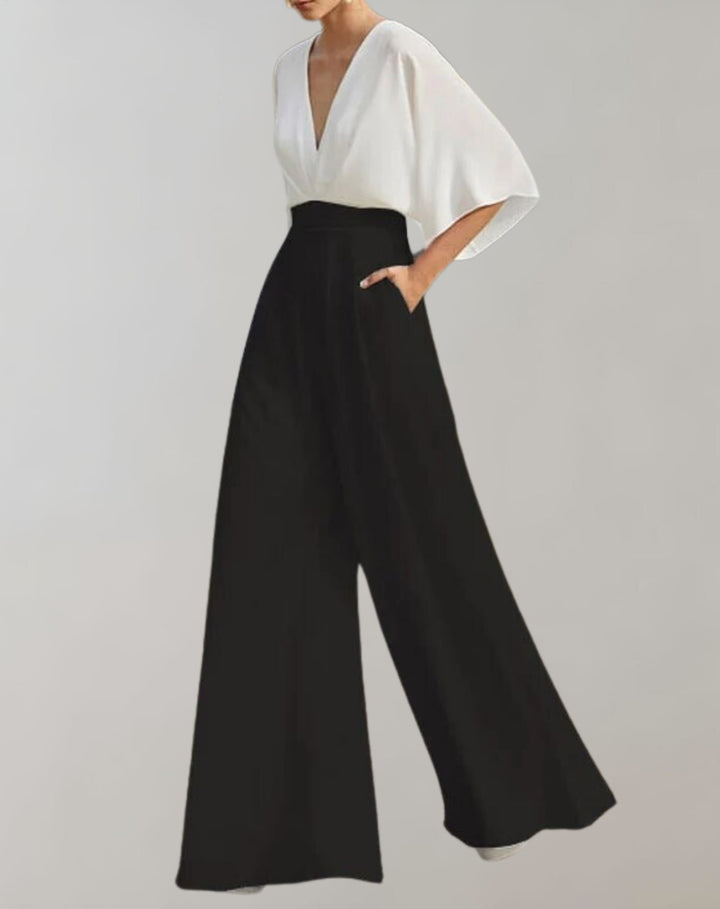 Side view of women's wide-leg batwing jumpsuit highlighting the flowing sleeve drape