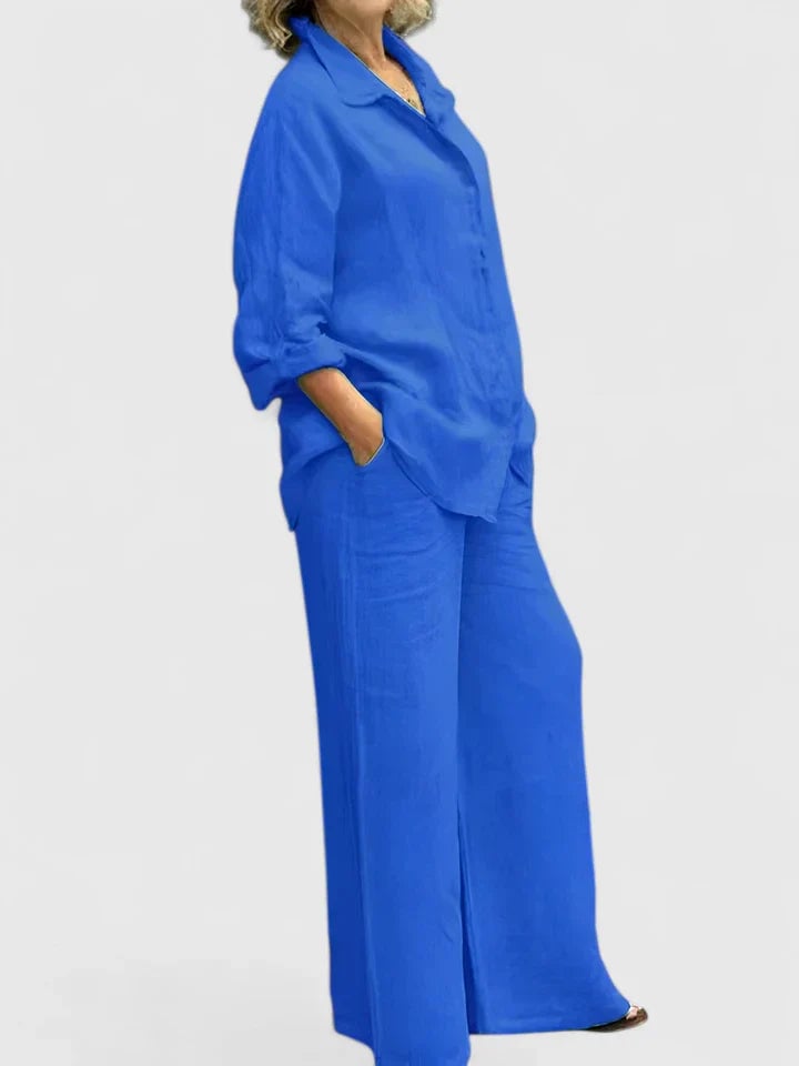 Model wearing Roslyn linen set in gray with shirt half-tucked into wide-leg pants