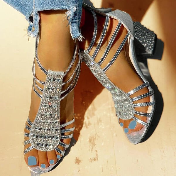Rowan women's shimmer sandals in Silver colorway, styled flat lay on neutral background