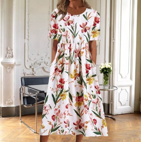 Woman wearing the Ruby floral midi dress in a colorful floral print, showing the full A-line silhouette