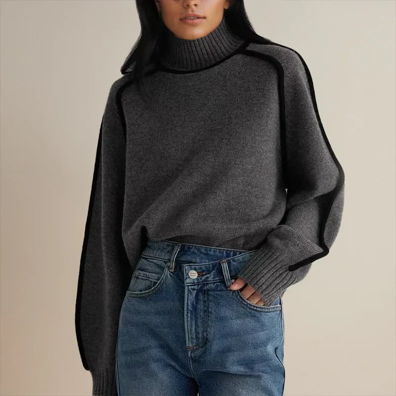Woman wearing the Ruby soft and elegant sweater in a neutral brown colorway, styled casually