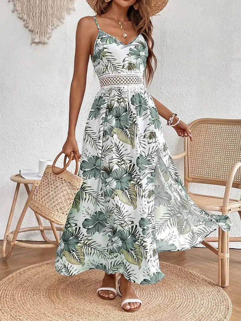Woman wearing the Ruby floral flowy draped midi dress in green, showing the full relaxed silhouette against a bright summer backdrop