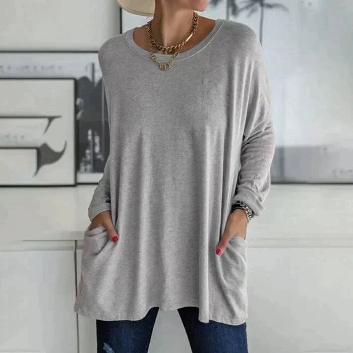 Side view of the Ruby oversized tunic top in black highlighting the flared hem and sleeve length