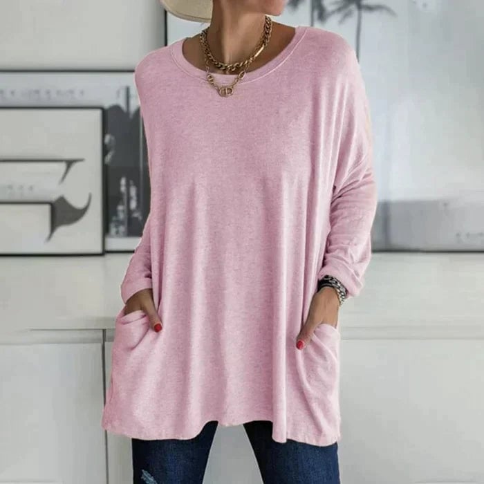 Close-up of the front patch pocket detail on the Ruby knit tunic top in black