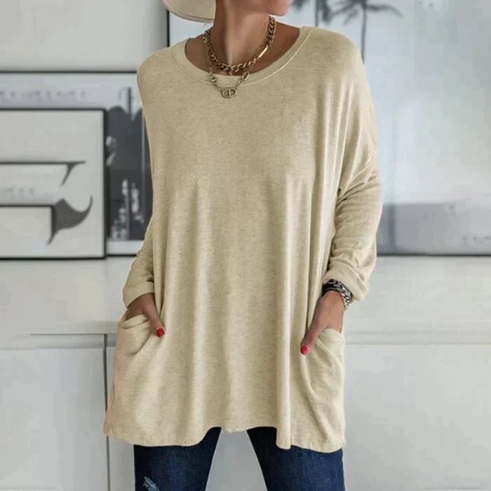 Woman wearing the Ruby tunic top in red pink styled with slim-fit jeans