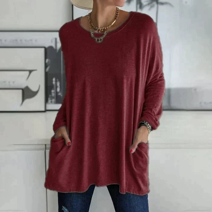 Woman wearing the Ruby oversized tunic top in white paired with casual bottoms