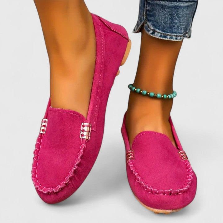 Ruby suede slip-on loafers in pink with moccasin stitch detail and gold bar accent, front view