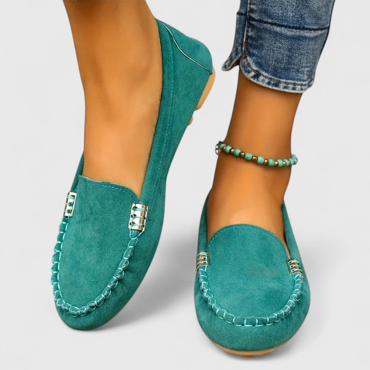 Ruby suede loafers in green on a flat surface, showcasing the slip-on silhouette
