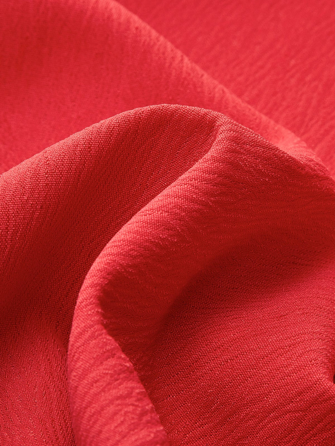Flat lay of all four colorways of the Ruby V-neck mini dress — red, apricot, blue, and black