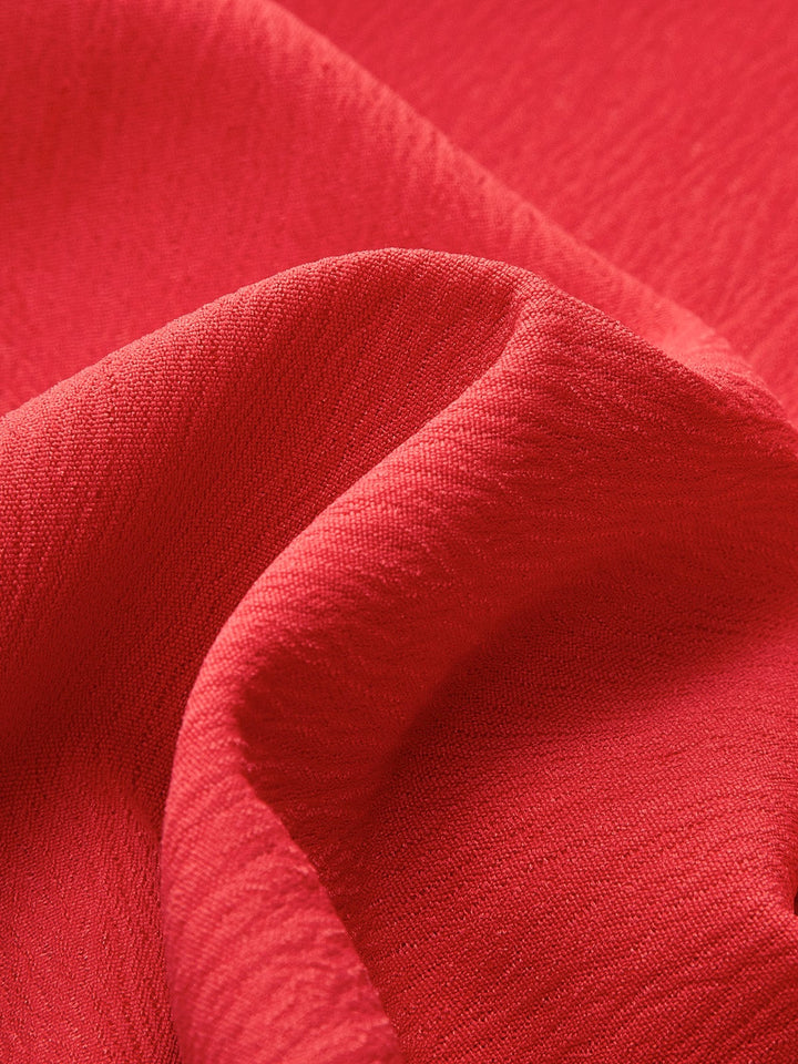 Flat lay of all four colorways of the Ruby V-neck mini dress — red, apricot, blue, and black
