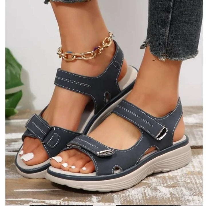 Flat lay of all four Rue sandal color options: black, beige, brown, and blue