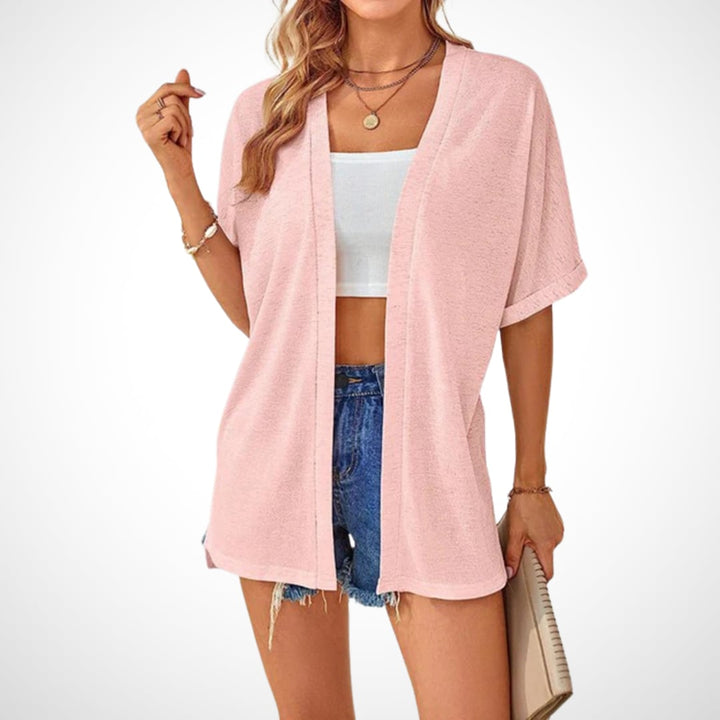 Flowy short sleeve cardigan in navy blue draped over a woman's shoulders for a casual look