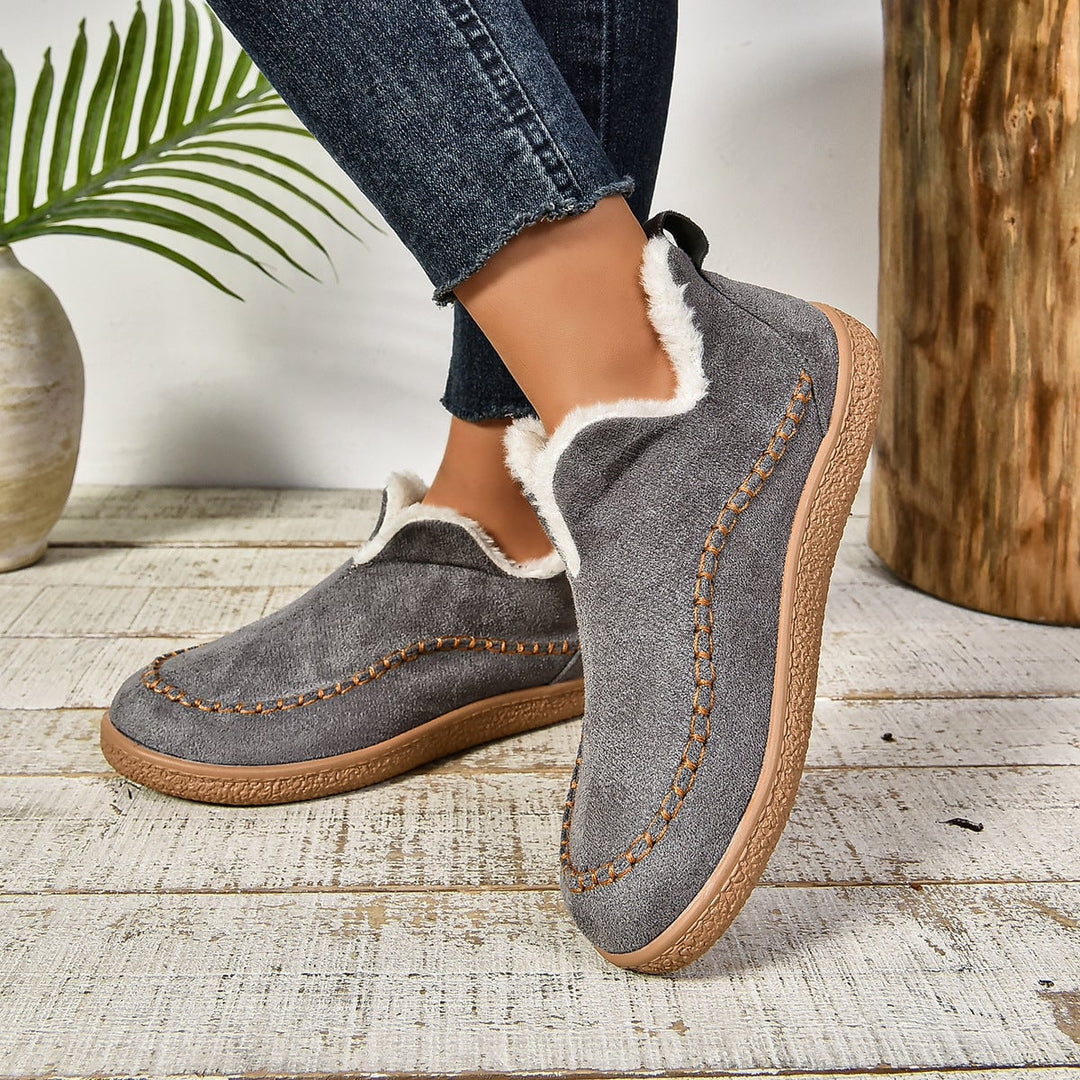 Close-up of anti-slip textured sole on women's fur-lined slip-on ankle boots
