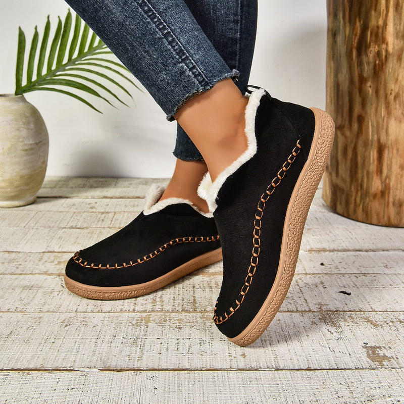 Women's fur-lined slip-on ankle boots in grey shown from a front angle